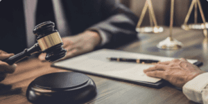 Nursing home abuse lawyer negotiating at a desk with the scales of justice and gavel.