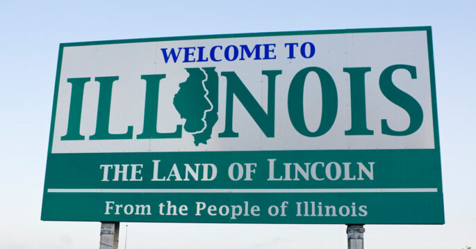 Welcome to Illinois sign featuring the outline of the state and the text 'The Land of Lincoln' and 'From the People of Illinois'.